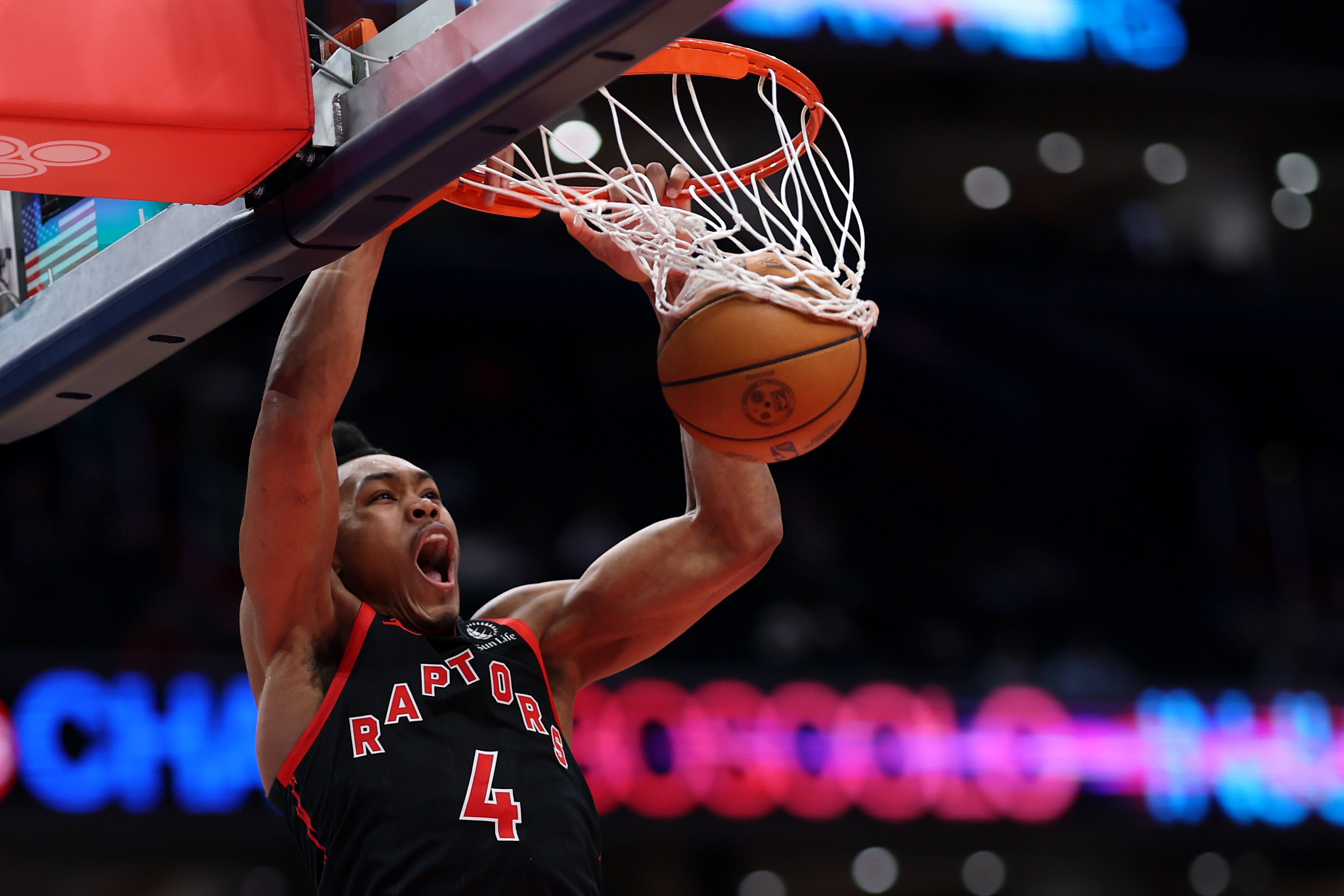 Scottie Barnes dunks during a game. 