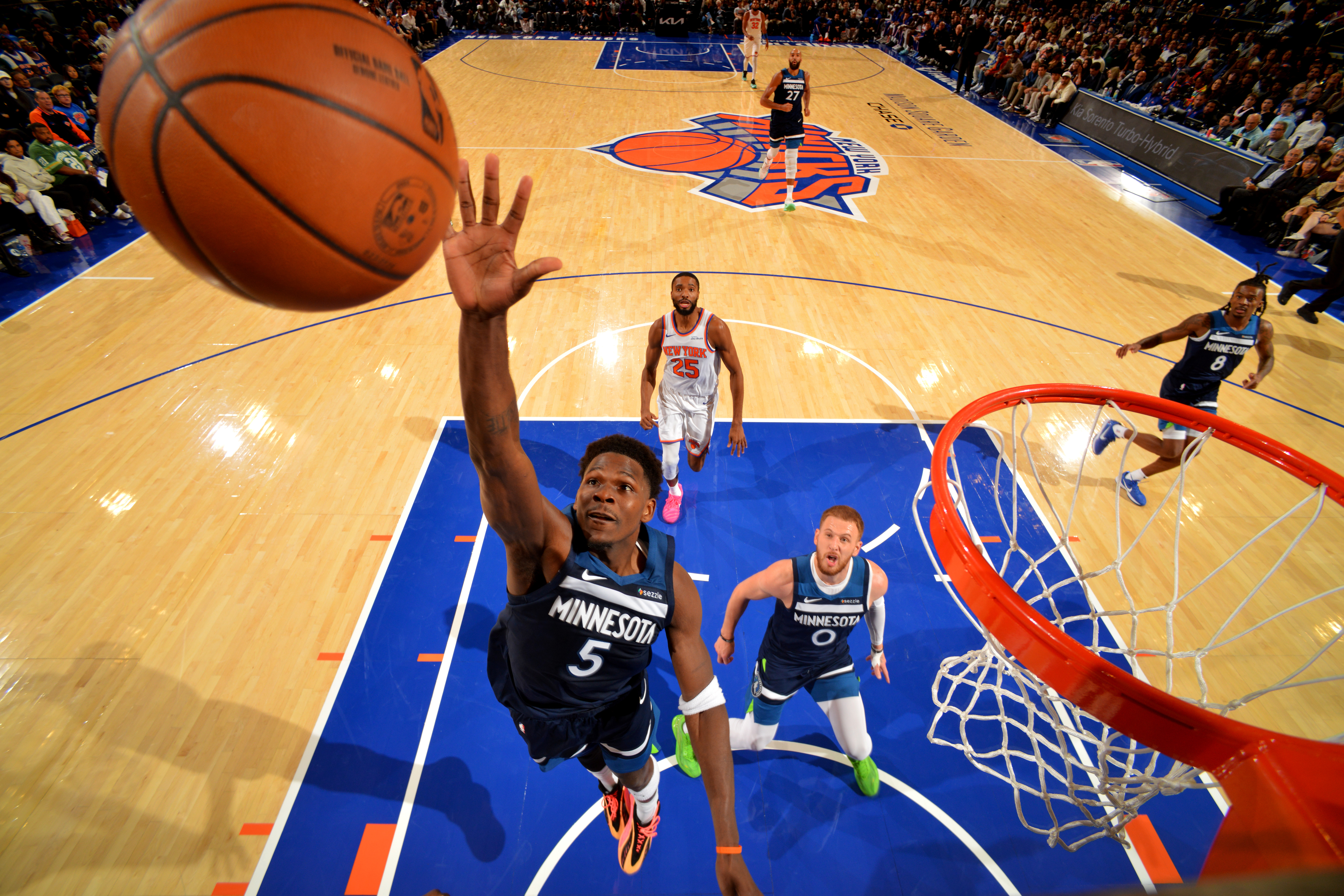 Anthony Edwards leaps for a rebound. 