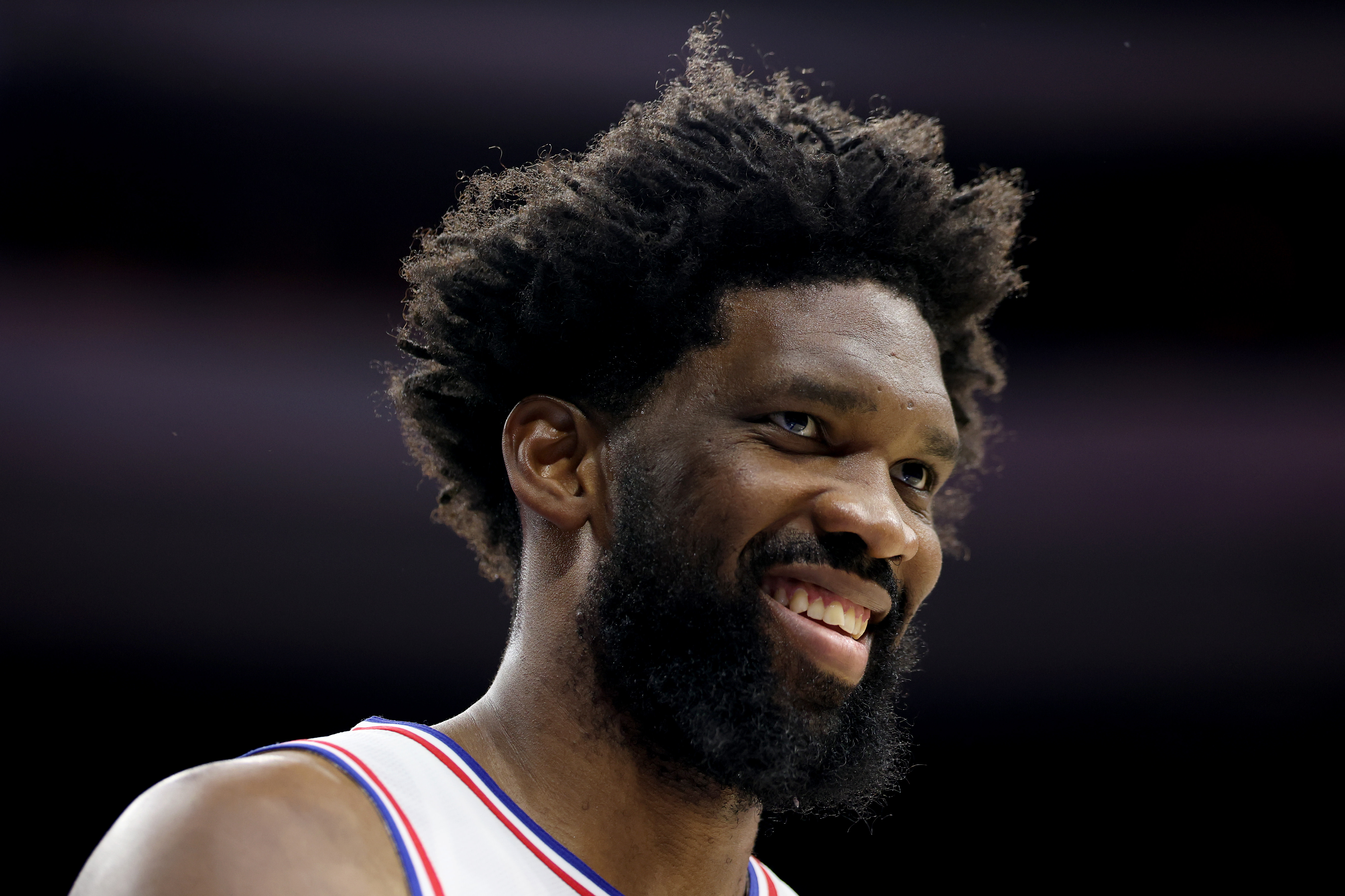 Joel Embiid smiles during a preseason game. 